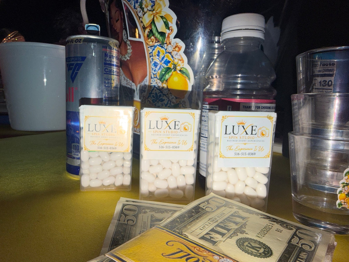 Personalized novelty money displayed with Luxe Spin Studio favors