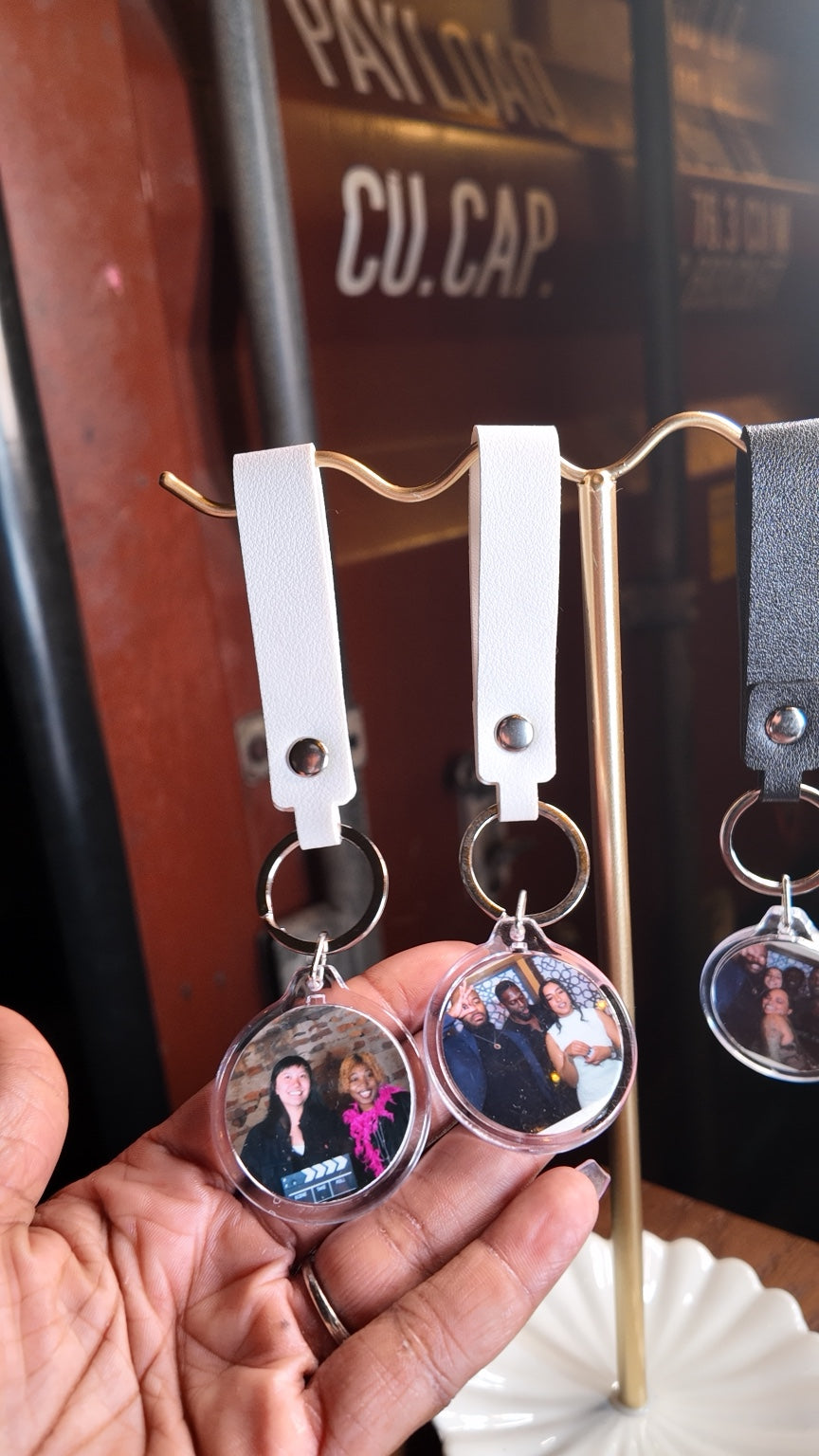Luxe Spin Studio round photo keychains with white and black wrist straps at Bushwick Film Festival
