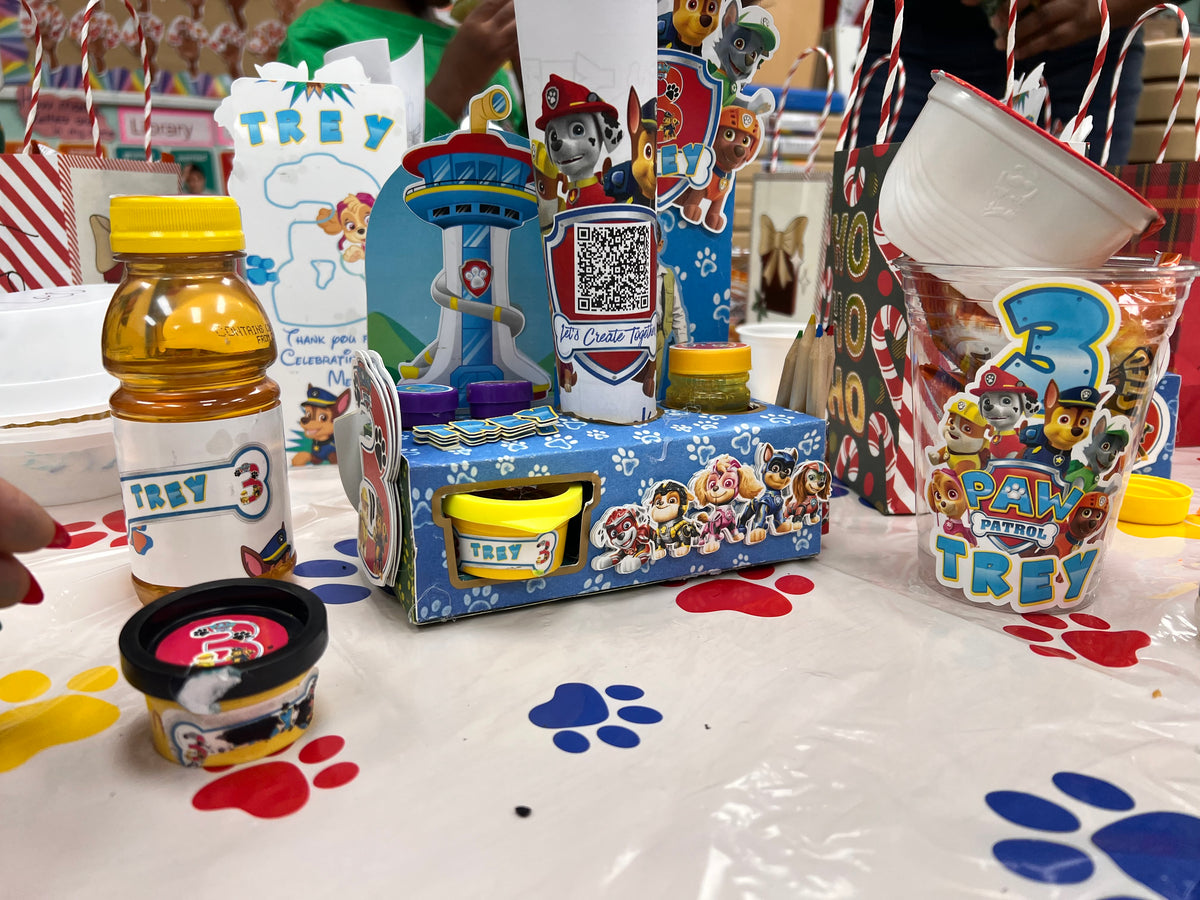 Paw Patrol-themed children's activity favors displayed with Play-Doh and party items.