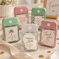 Personalized mint green, blush pink, and clear card-style hand sanitizer party favors